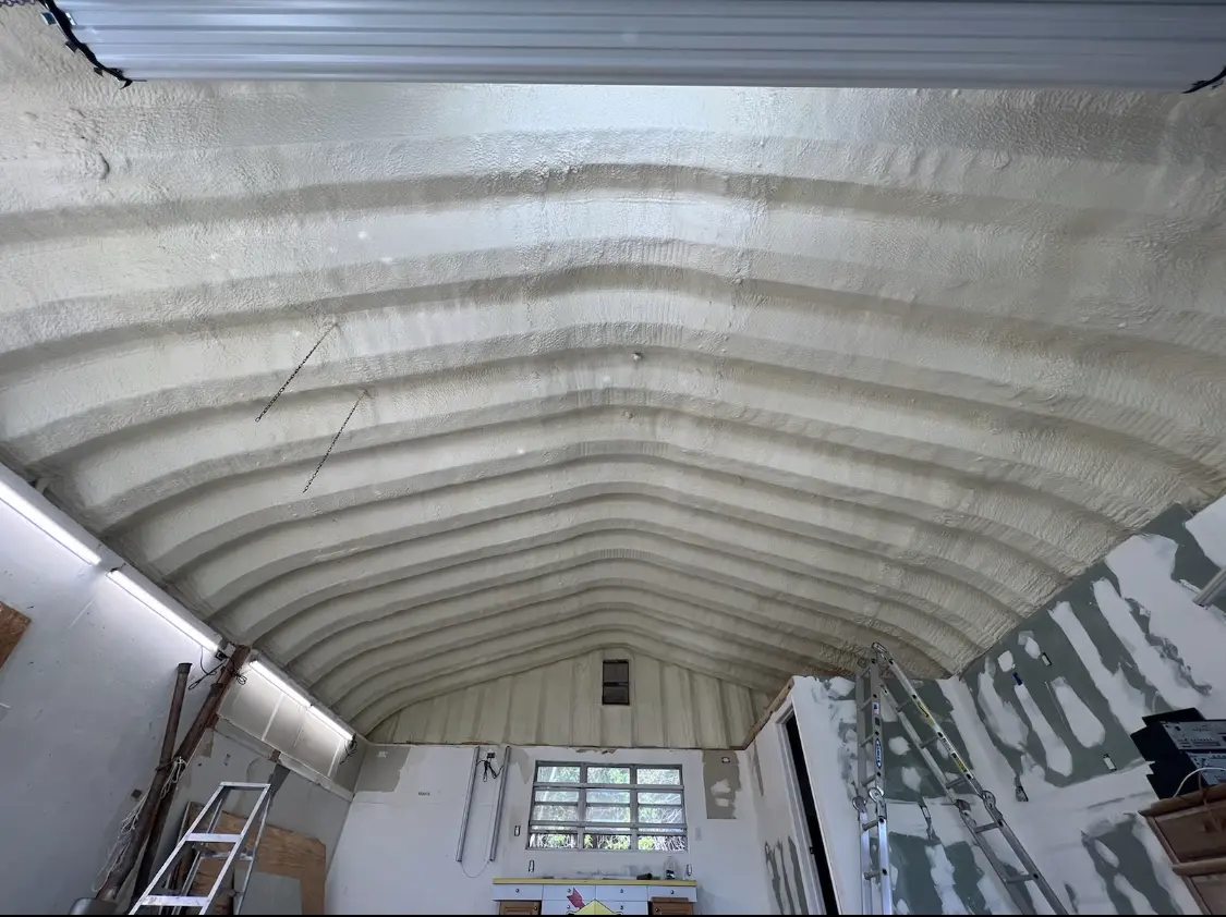 Spray polyurethane foam applied to the underside of a metal roof deck in Wedgefield